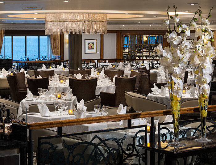 Elegantes Restaurant mit eleganter Tischdeckung und Fensterplätzen mit Meerblick