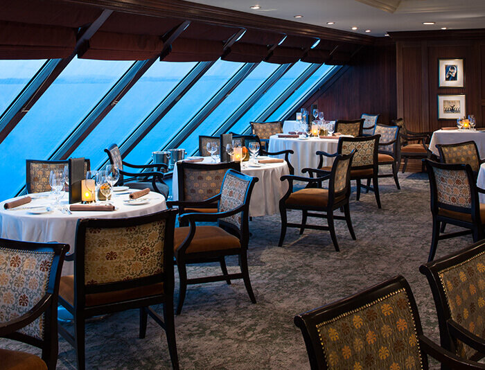 Elegantes à-la-carte Restaurant mit großen Fenstern und Meerblick