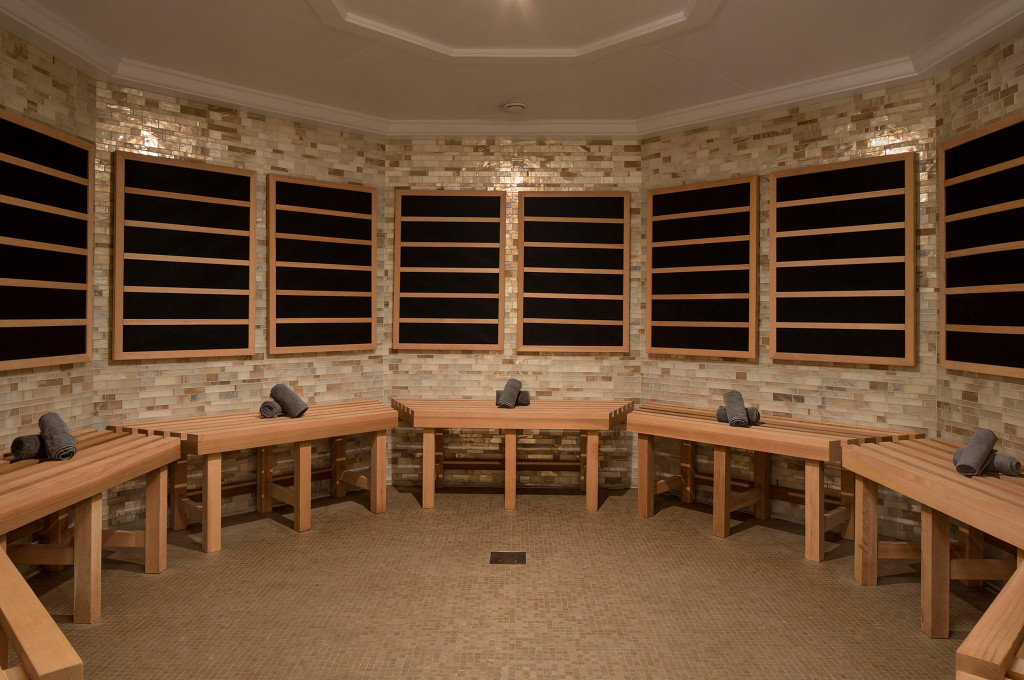 Luxuriöser Spa-Saunabereich mit Ziegelmauer und Holzbänken für Gäste der Hochseekreuzfahrt.