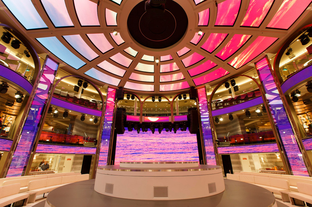 Rundes Atrium Colosseo auf der Costa Smeralda mit LED-Decke, beleuchteter Bühne und mehrstöckiger Ringstruktur.
