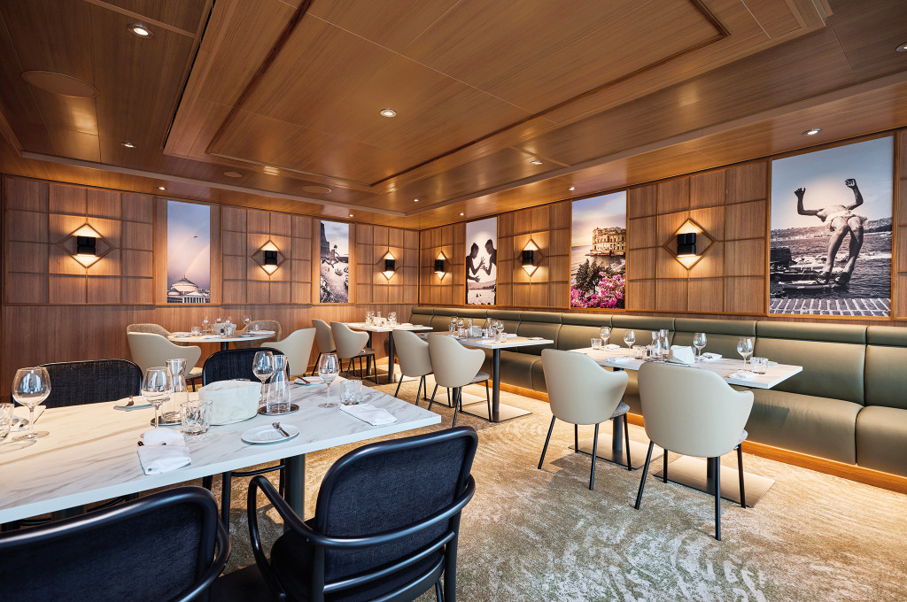 Osteria mit holzvertäfeltem Speiseraum, italienischen Wandbildern und weiß gedeckten Marmortischen.