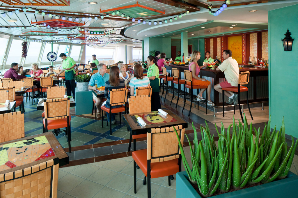 Rita's Cantina Bar mit tropischem Dekor und farbigen Stühlen auf Hochseeschiff