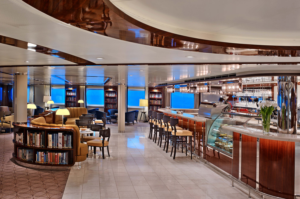 Seabourn Square auf der Seabourn Ovation mit Bibliothek, Café-Theke, Lounge-Sitzgruppen und Panoramafenstern.