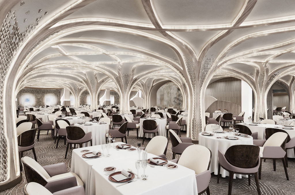 Hauptrestaurant Compass Rose mit eindrucksvoller geschwungener Deckenarchitektur, weiß eingedeckten Tischen und gepolsterten Stühlen an Bord der Seven Seas Grandeur.